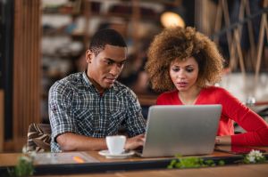 African American business colleagues working together on a laptop.