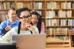 Attractive young woman at the library- chin on hand