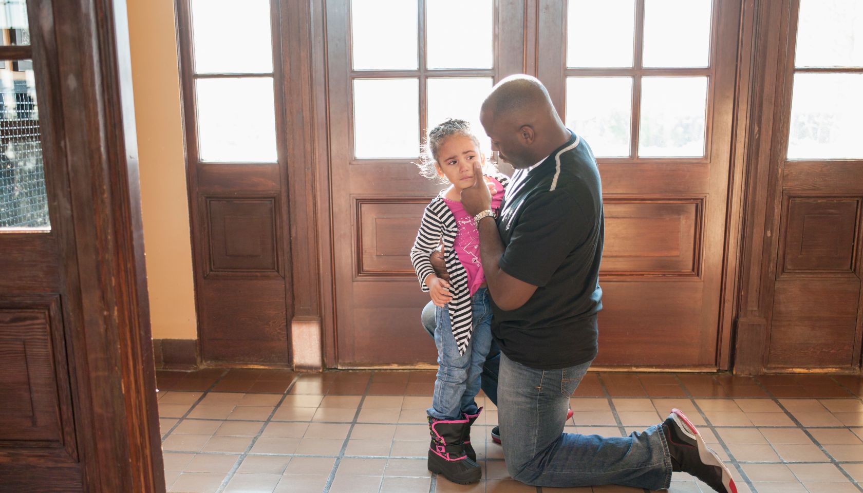 Father comforting his crying daughter