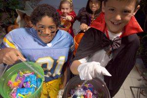 Children (4-8) in Halloween costumes trick-or-treating, elevated view