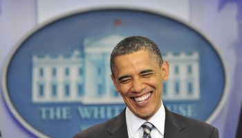US President Barack Obama smiles as he m