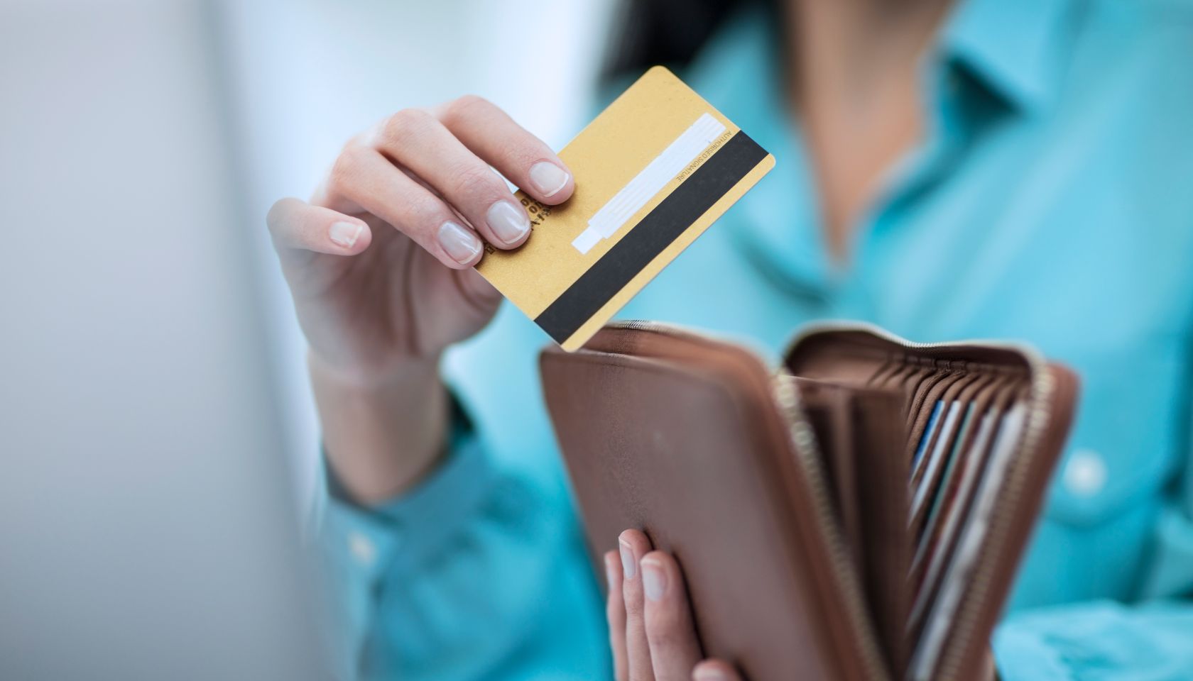 Person with wallet and credit card