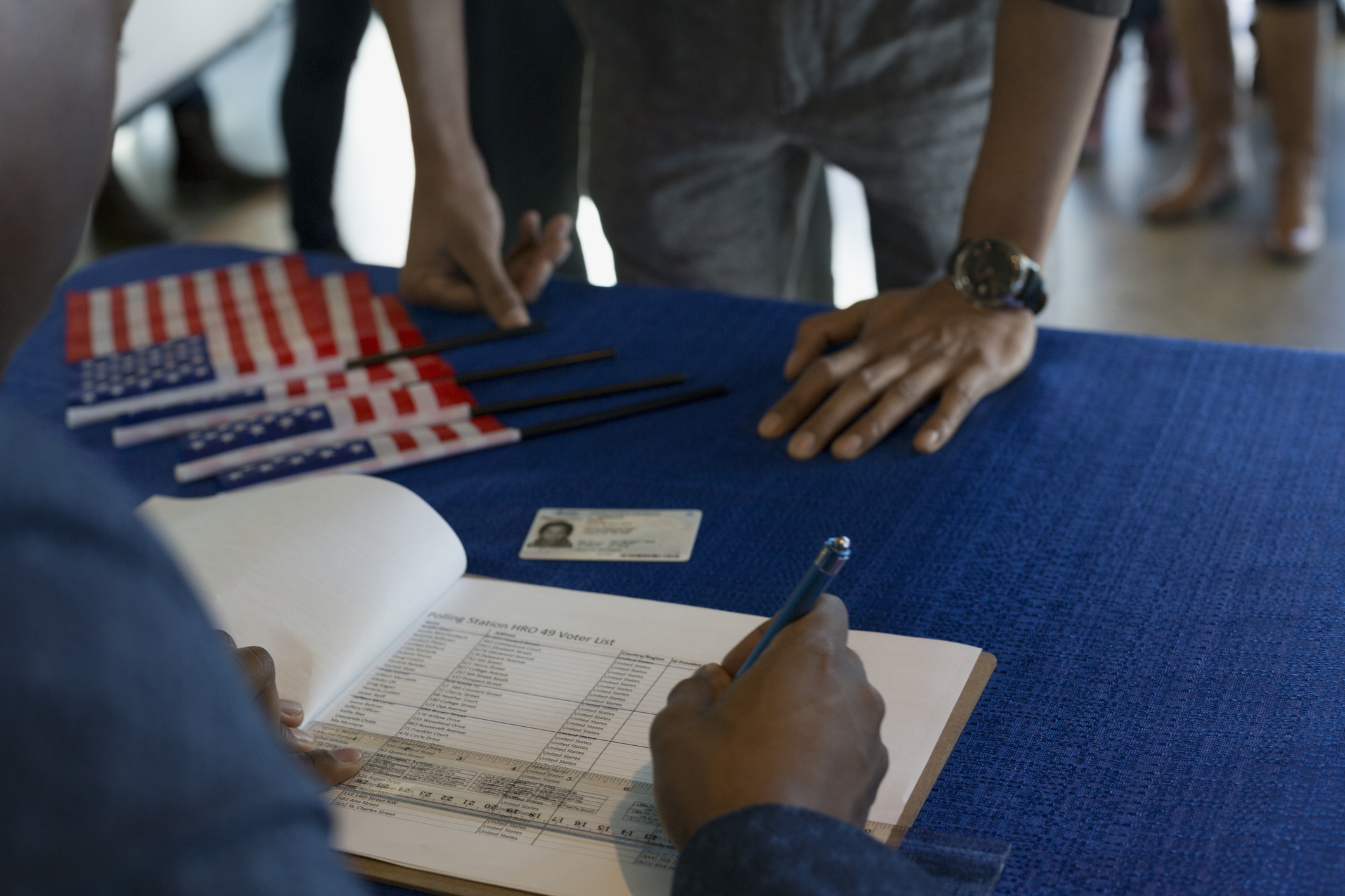 Volunteer checking voters in at polling place