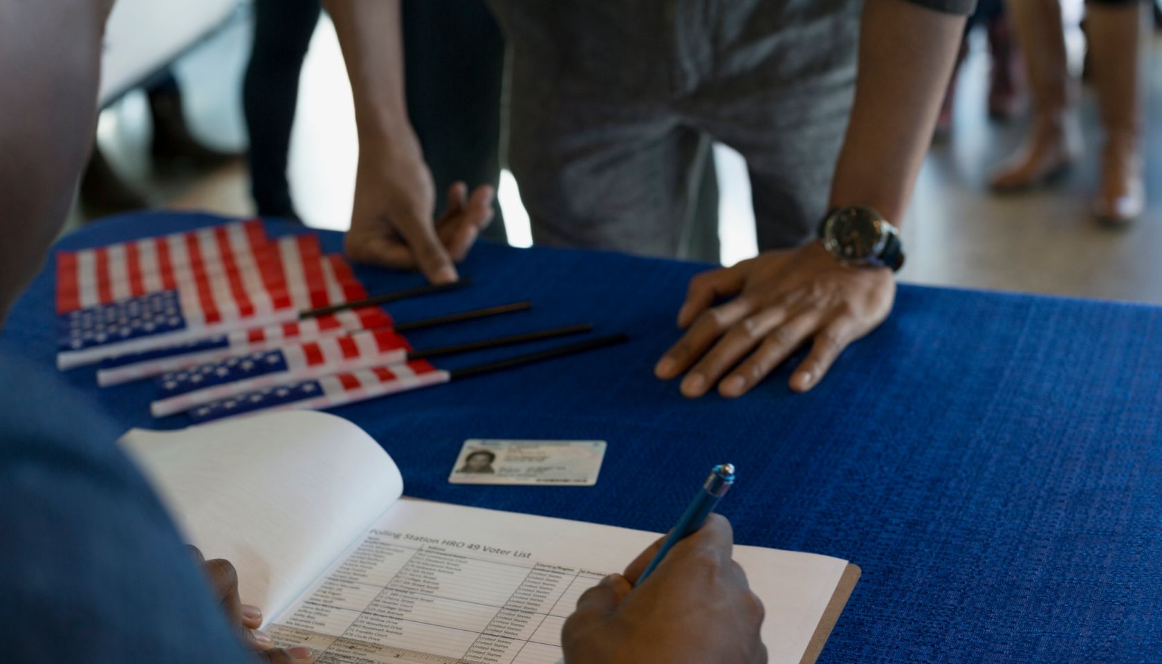 Volunteer checking voters in at polling place