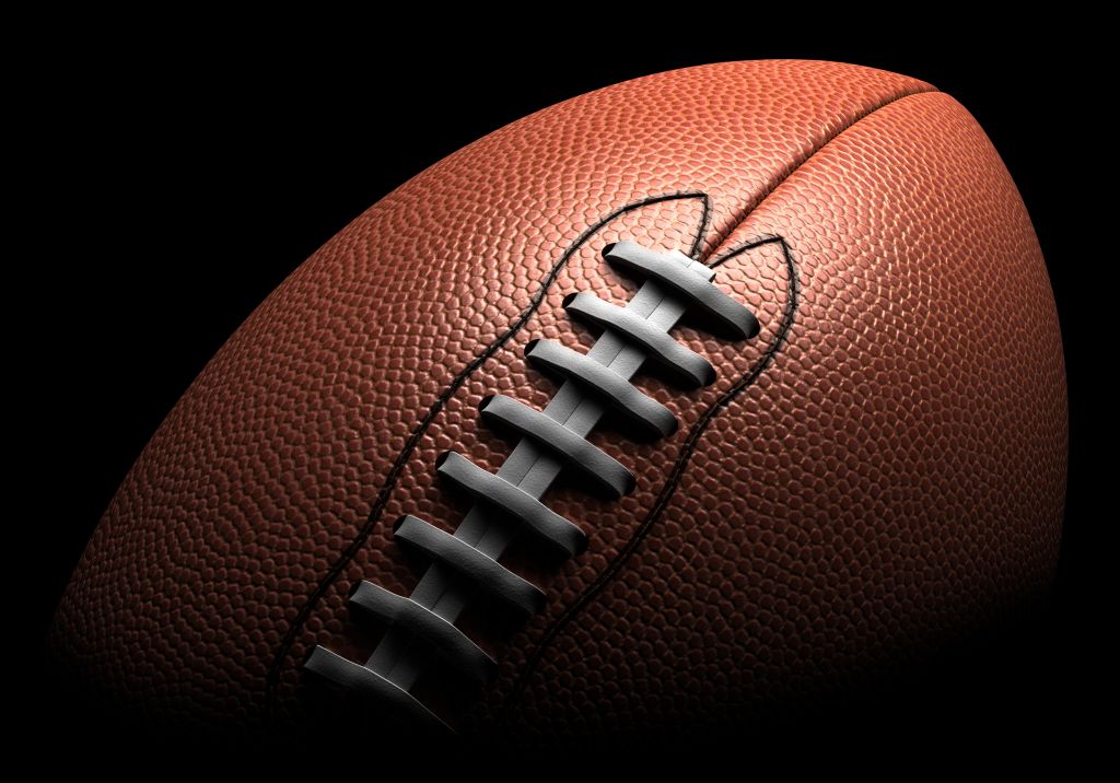 American football on black background, close-up