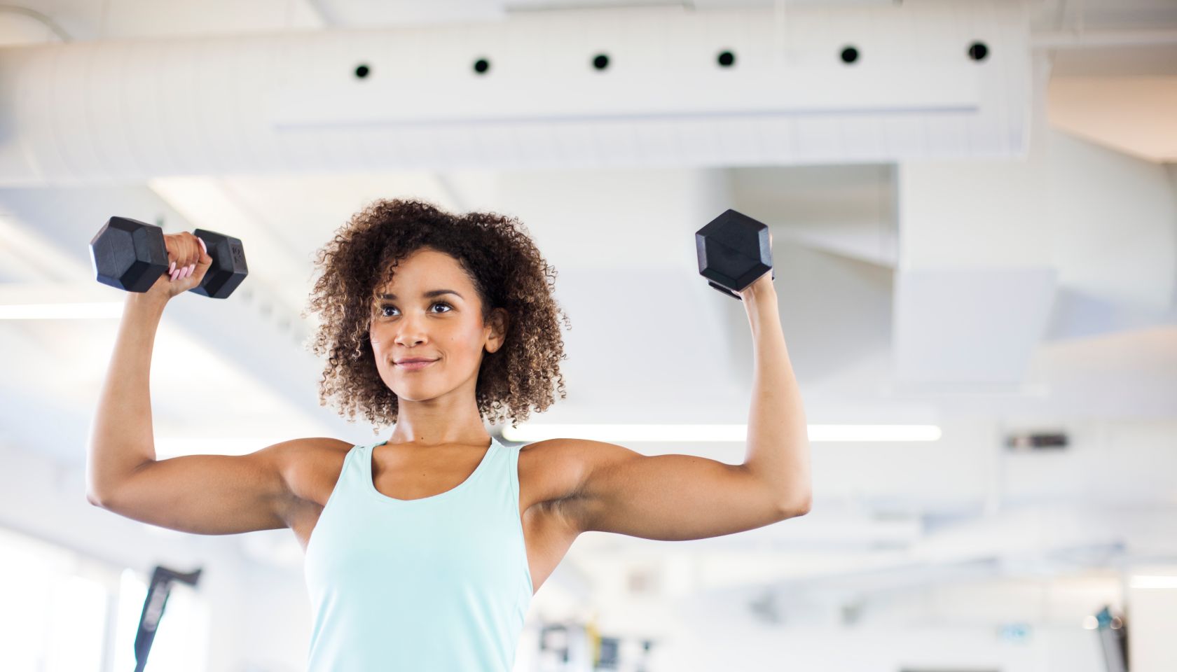 Young Woman Weightraining at the Gym