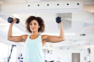 Young Woman Weightraining at the Gym
