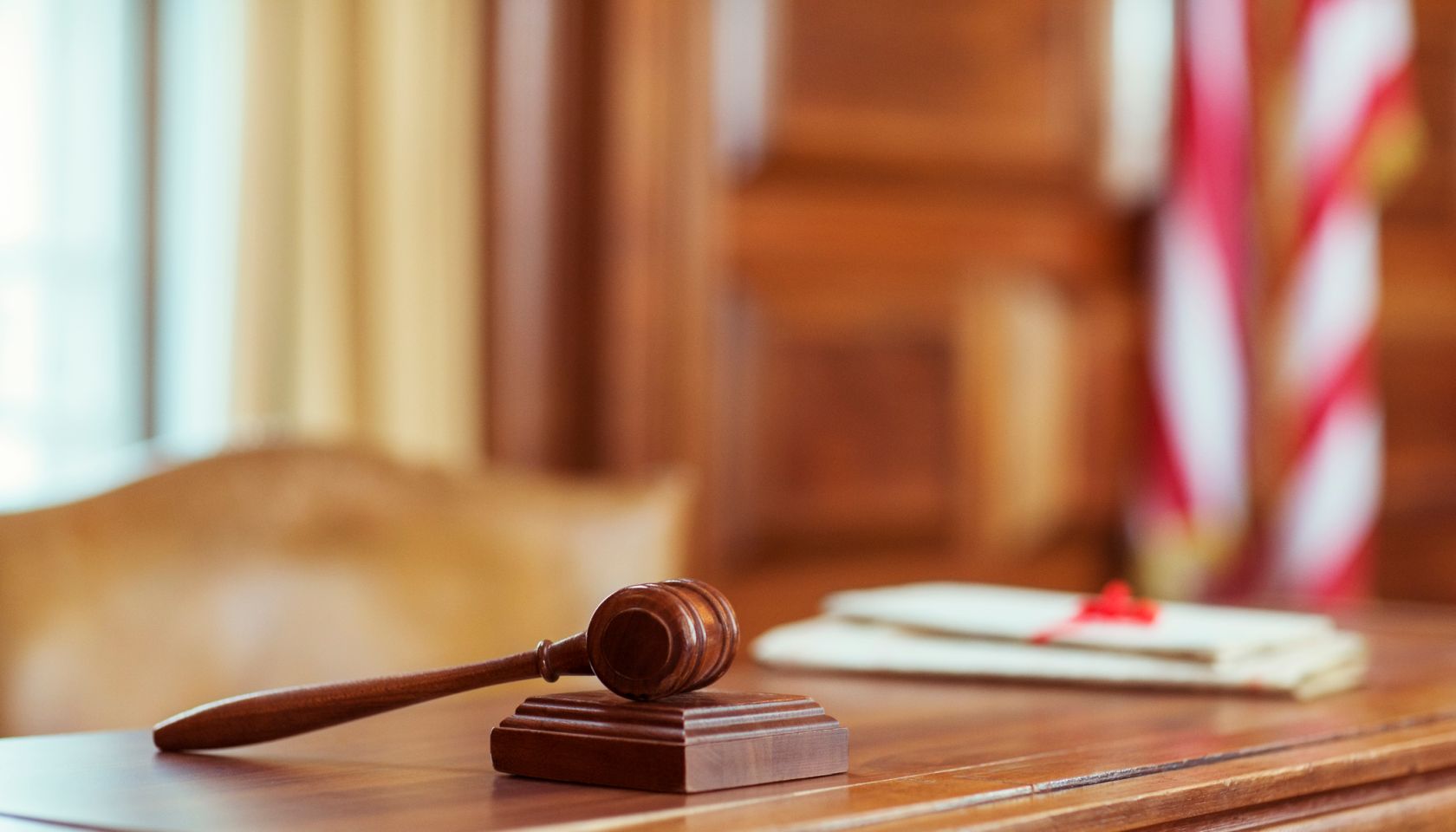 Gavel laying on judges bench in courtroom