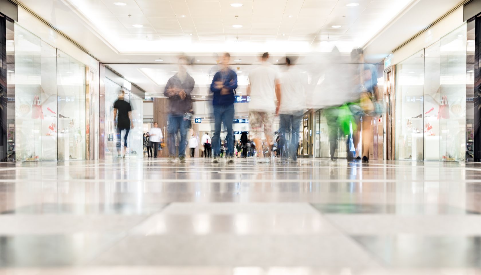 Motion blurred customers walking in shopping mall, Hong Kong