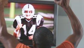 CU SHAKY Man watching sports on TV, Phoenix, Arizona, USA