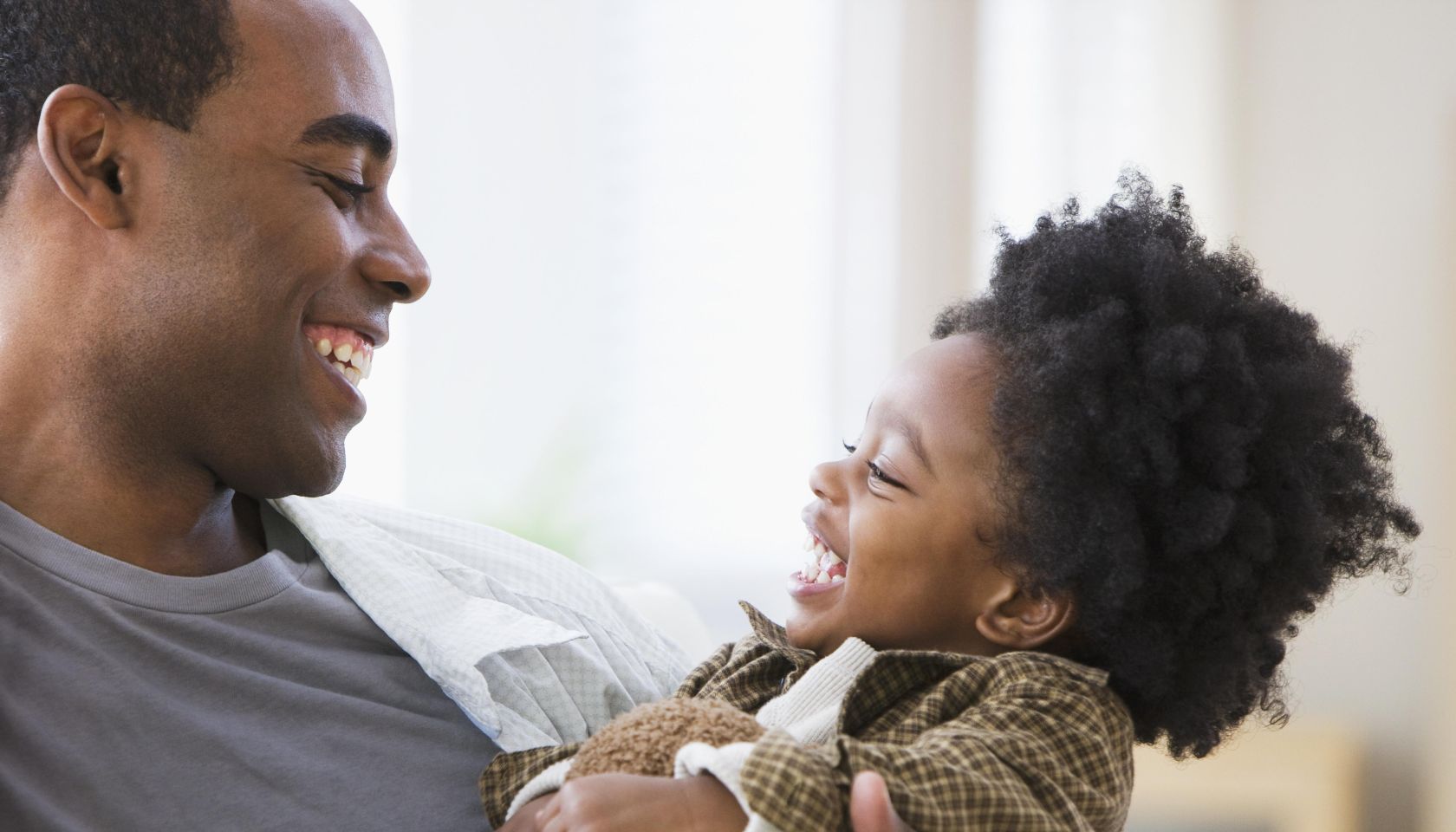 African American father smiling at son