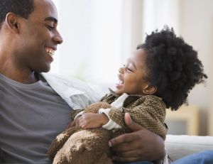 African American father smiling at son